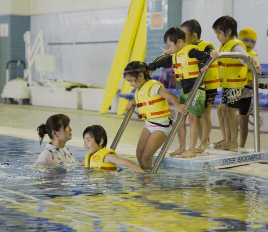 Students from Kawashimo Yochien in Iwakuni City, celebrate their last day at the IronWorks pool aboard Marine Corps Air Station Iwakuni, Japan, July 21, 2015. Coming to the station pool is an honor unique to the senior kindergarten class and is a 30-year tradition.