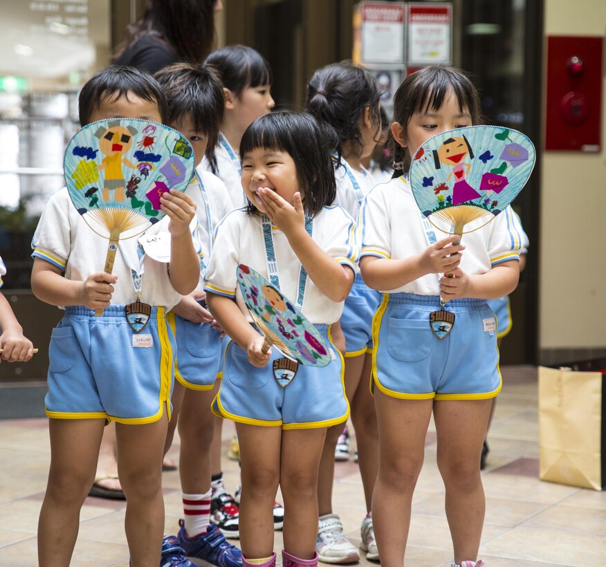 Students from Kawashimo Yochien in Iwakuni City, celebrate their last day at the IronWorks pool aboard Marine Corps Air Station Iwakuni, Japan, July 21, 2015. To commemorate the last day at the pool, Kawashimo Yochien staff hosted a luncheon at the Crossroads food court. To show their thanks and gratitude, the kindergarten class decorated fans with photographs of their swimming adventures, made ribbons expressing thanks and presented them to the special staff and guests who made it possible for them to enjoy their time at the pool.