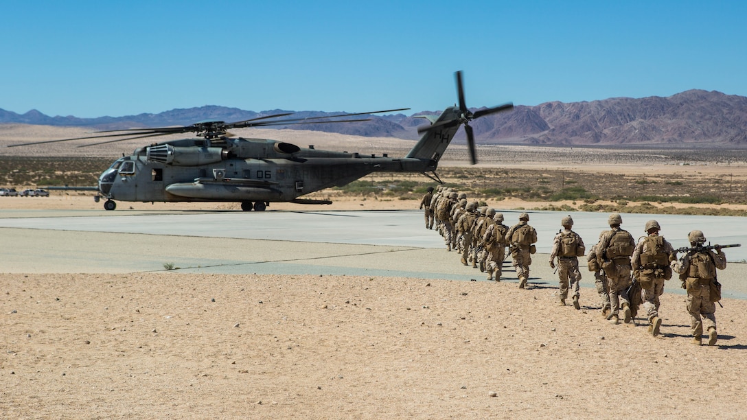 Marines with Company B, 1st Battalion, 3rd Marine Regiment, prepare to load onto a CH-53E Super Stallion with Marine Heavy Helicopter Squadron 366 aboard Marine Corps Air Ground Combat Center Twentynine Palms, Calif., July 26. The Marines were inserted into an urban terrain to cordon and search the area for possible threats.