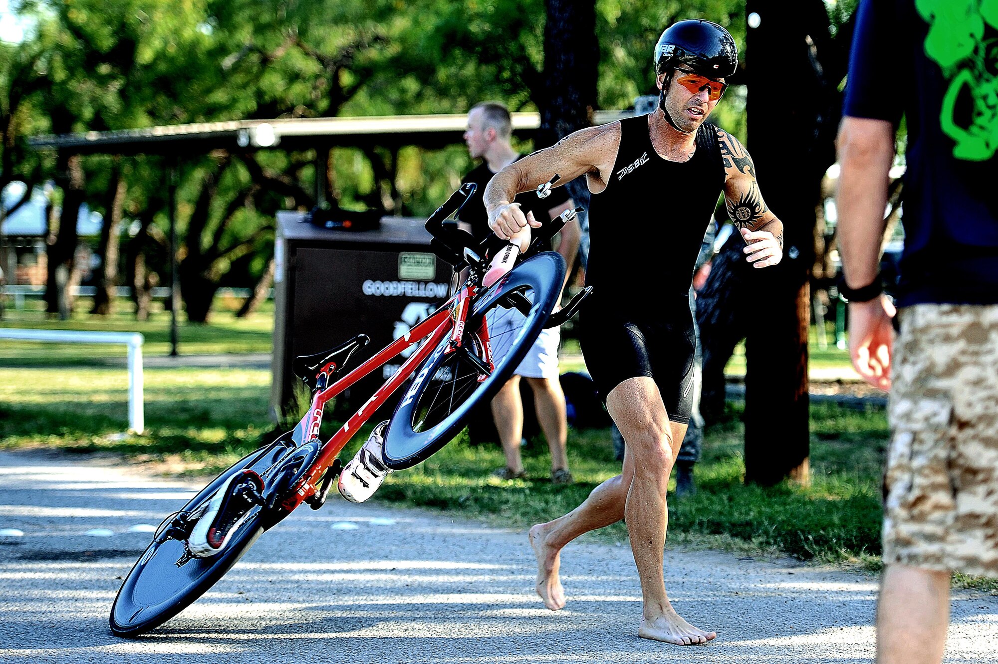 Brian Lemaster, 344th Military Intelligence Battallion contractor, transitions from the cycling portion of the 8th Annual Goodfellow Triathlon at the Goodfellow Air Force Base Recreation Camp in San Angelo, Texas, July 25, 2015.  Lemaster went on to win first place in his age group. (U.S. Air Force photo by Tech. Sgt. Austin Knox/Released)
