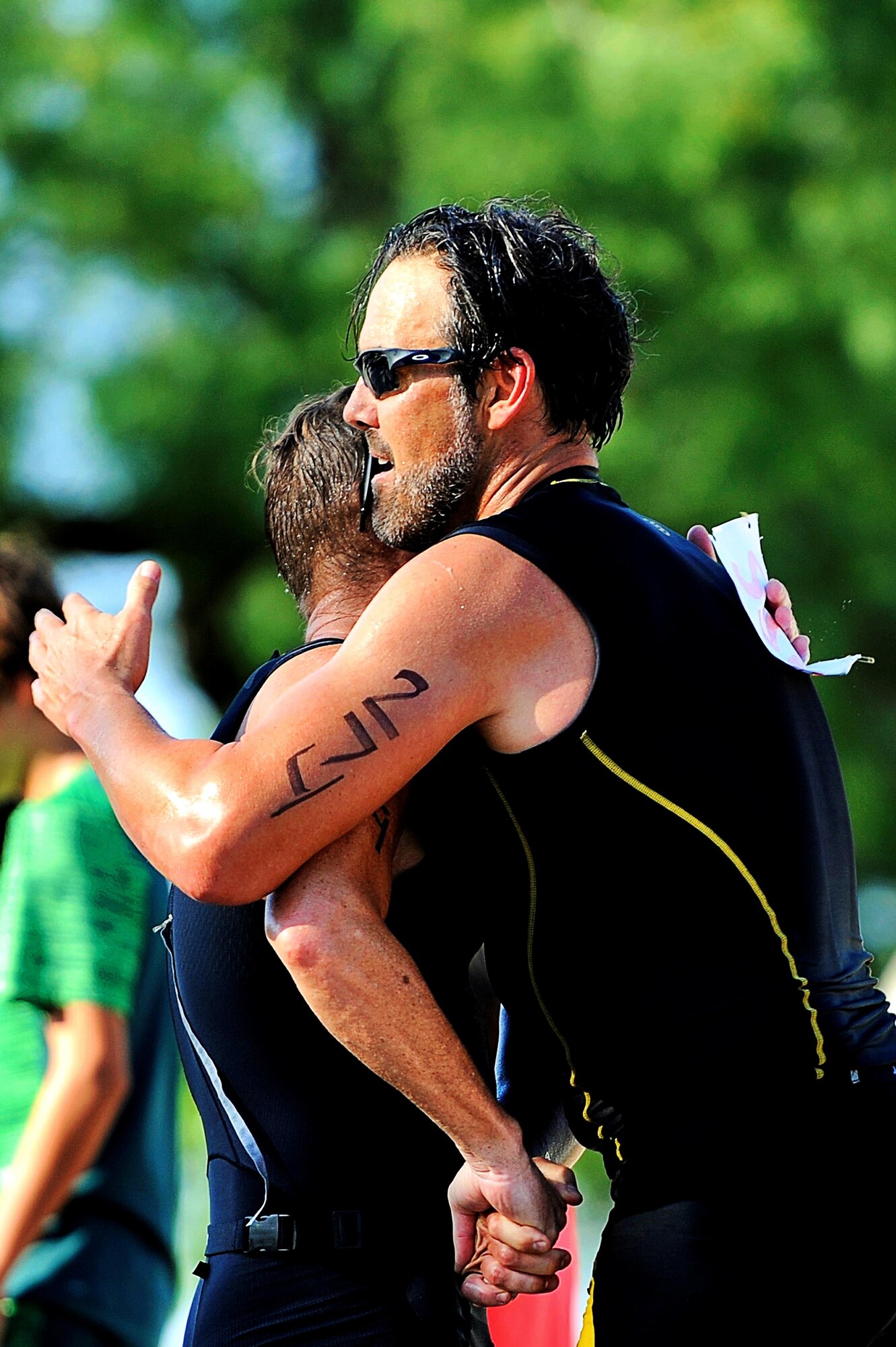 Shane Plymell, number 274, and Brian Lemaster congratulate each other after finishing the 8th Annual Goodfellow Triathlon at the Goodfellow Air Force Base Recreation Camp in San Angelo, Texas, July 25, 2015. Lemaster won their age group this year against Plymell, the returning champion. (U.S. Air Force photo by Tech. Sgt. Austin Knox/Released)