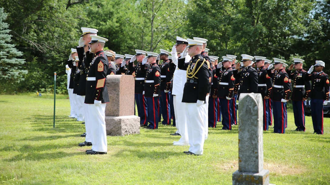 Lt. Gen. Richard P. Mills, commander of Marine Forces Reserve, and Marines of and sailors of Marine Forces Reserve, salute as TAPS is played for Sgt. Carson Holmquist, a motor transport maintenance chief with and Battery M, 3rd Battalion, 14th Marine Regiment, 4th Marine Division, Marine Forces Reserve, during his funeral July 25, 2015 in Grantsburg, Wisconsin Holmquist, along with three other Marines and a sailor, was killed in an attack at the Naval Operation Support Center and Marine Corps Reserve Center in Chattanooga, Tennessee July 16, 2015. Marines, family, friends and the community of Grantsburg gathered to honor the memory and sacrifice of Holmquist and his fallen brothers-in-arms. 