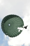 Indiana National Guardsmen earn their German jump wings under the watchful eye of two German Jumpmasters. The Soldiers took their commands from the Germans and jumped from a C-130 over Camp Atterbury on July 22, 2015.