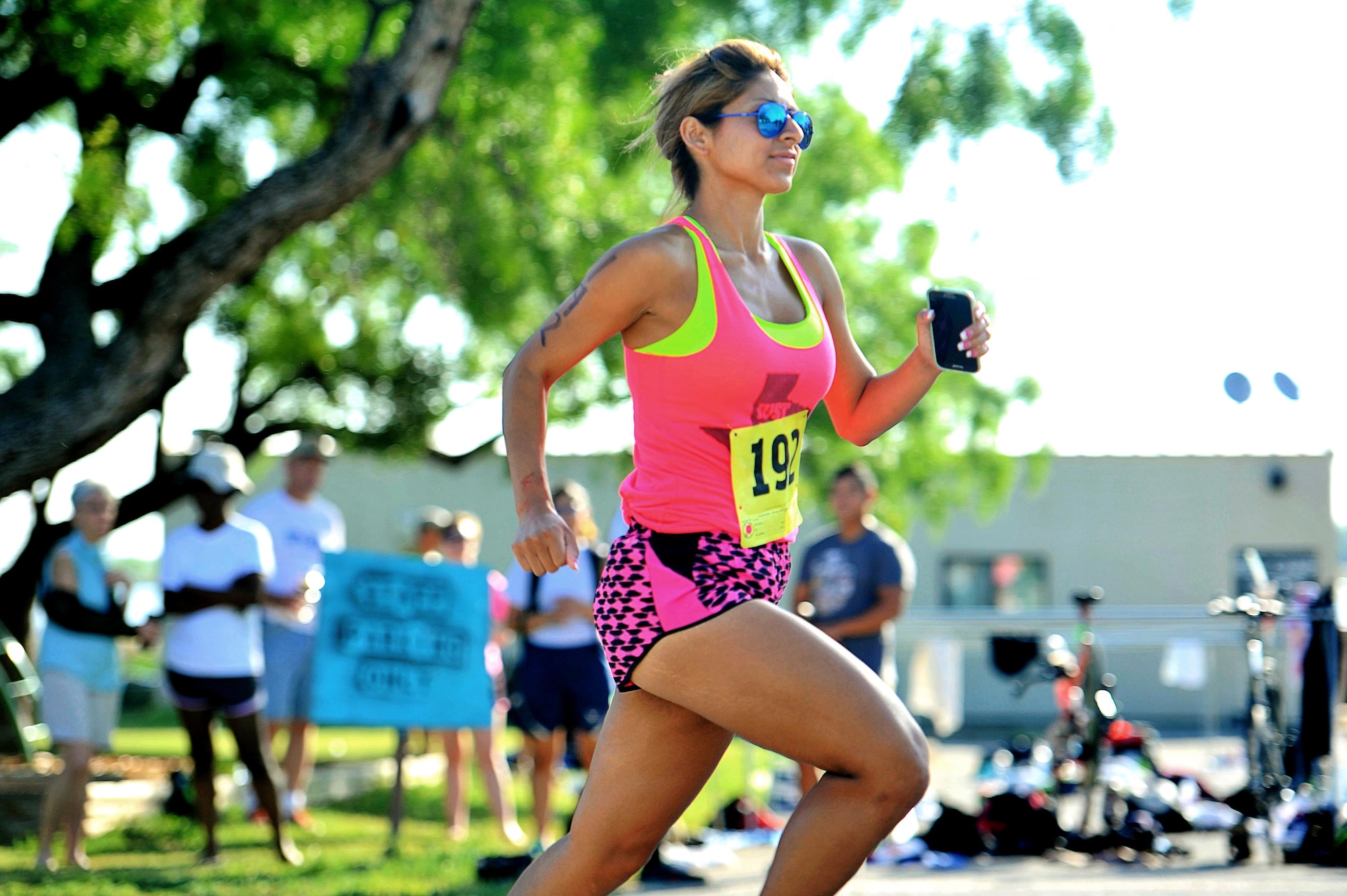 Denise Rios, race participant, starts the running portion of the 8th Annual Goodfellow Triathlon at the Goodfellow Air Force Base Recreation Camp in San Angelo, Texas, July 25, 2015. The 17th Force Support Squadron hosted the event which consisted of a 400-meter open water swim, a 20-kilometer bicycle ride and a 5-kilometer run. (U.S. Air Force photo by Tech. Sgt. Austin Knox/Released)  