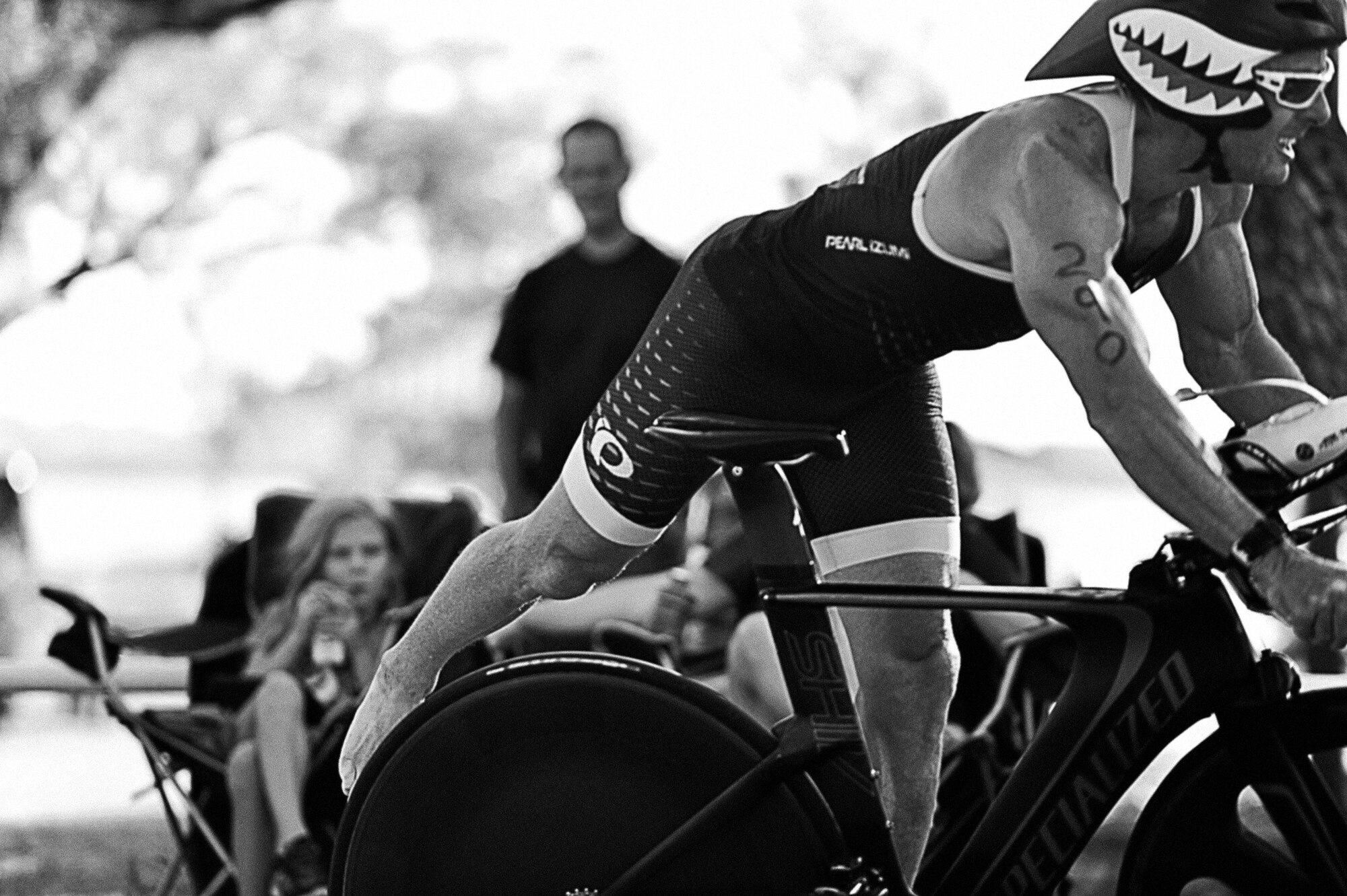 Cory Sanders prepares to dismount his bicycle for the running portion of the 8th Annual Goodfellow Triathlon at the Goodfellow Air Force Base Recreation Camp in San Angelo, Texas, July 25, 2015. Sanders went on to win first place in his age group. (U.S. Air Force photo by Tech. Sgt. Austin Knox/Released) 