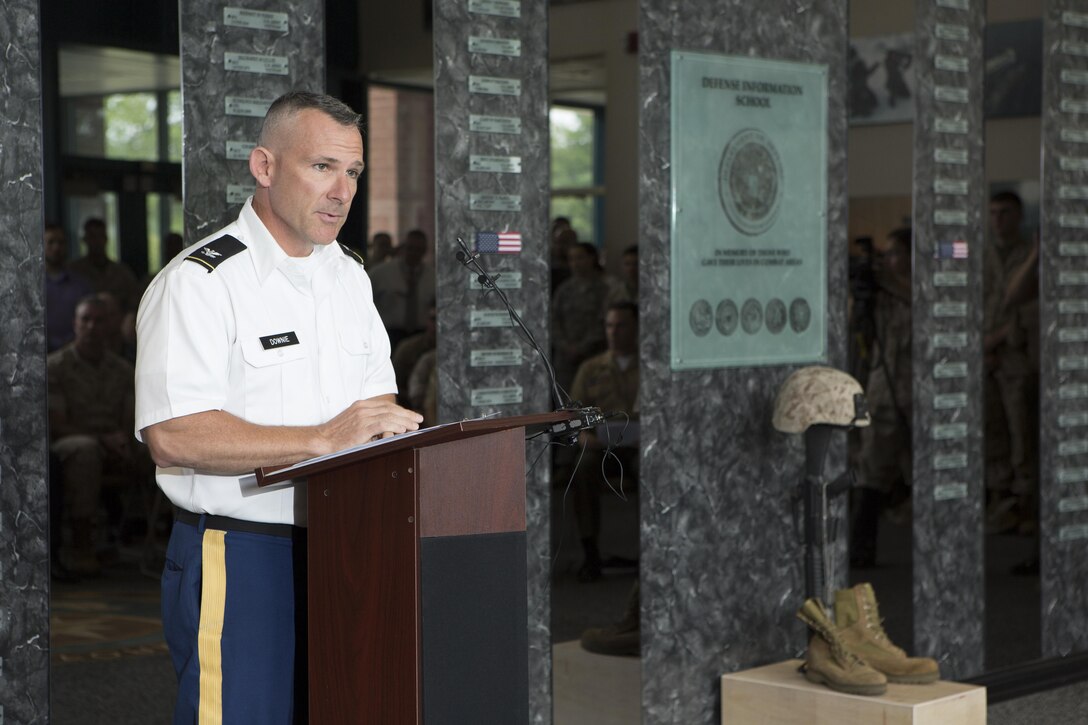 U.S. Army Col. Martin Downie, Defense Information School commandant, speaks during a memorial service and induction ceremony in the Hall of Heroes at DINFOS on Fort George G. Meade, Md., July 27, 2015. The ceremony was in honor of U.S. Marine Corps Cpl. Sara A. Medina and Lance Cpl. Jacob A. Hug, combat photographers who were killed during earthquake relief operations in Nepal, May 12, 2015. (DoD photo by Shane Keller/Released)