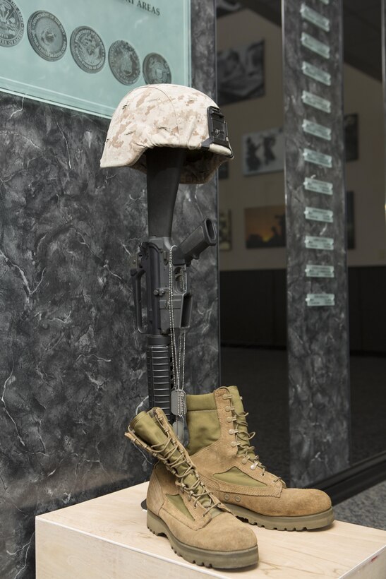 A battle cross sits on display in the Hall of Heroes for U.S. Marine Corps Cpl. Sara A. Medina and Lance Cpl. Jacob A. Hug at the Defense Information School on Fort George G. Meade, Md., July 27, 2015. Medina and Hug, combat photographers, were killed during earthquake relief operations in Nepal, May 12, 2015. (DoD photo by Shane Keller/Released)