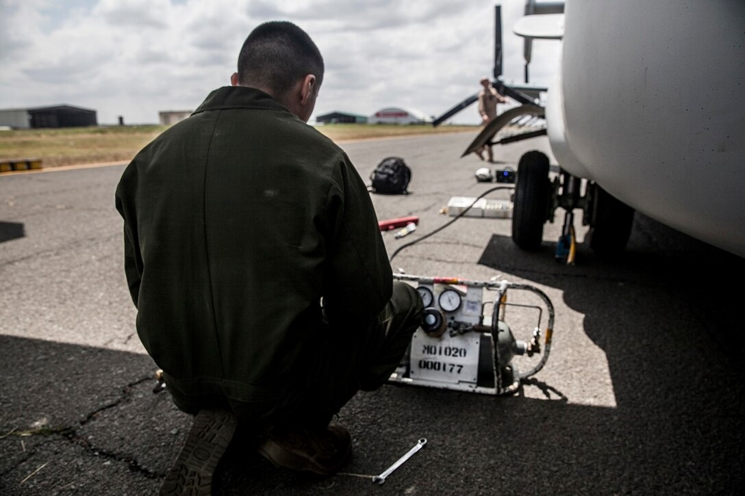 NAIROBI, Kenya (July 20, 2015) A U.S. Marine with the “Greyhawks” of Marine Medium Tiltrotor Squadron 161 (Reinforced), 15th Marine Expeditionary Unit, adds air to the tire of an MV-22B Osprey. The Marines are in Kenya to support President Barrack Obama’s upcoming visit. The “Greyhawks” are the aviation combat element of the 15th MEU which is embarked on the Essex Amphibious Ready Group and deployed to maintain regional security in the U.S. 6th Fleet area of operations. (U.S. Marine Corps photo by Cpl. Elize McKelvey/Released)