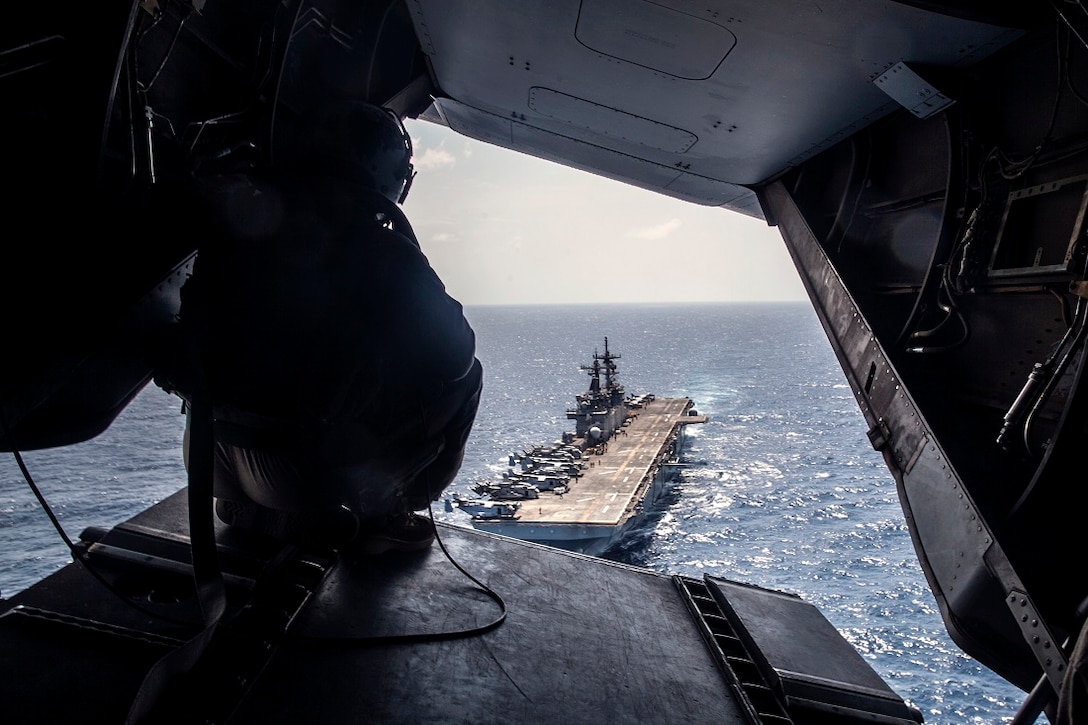 INDIAN OCEAN (July 19, 2015) A U.S. Marine with the “Greyhawks” of Marine Medium Tiltrotor Squadron 161 (Reinforced), 15th Marine Expeditionary Unit, overlooks the amphibious assault ship USS Essex (LHD 2) as they depart the ship in an MV-22B Osprey. The Marines are preparing to support President Barrack Obama’s visit to Kenya. The “Greyhawks” are the aviation combat element of the 15th MEU which is embarked on the Essex Amphibious Ready Group and deployed to maintain regional security in the U.S. 6th Fleet area of operations. (U.S. Marine Corps photo by Cpl. Elize McKelvey/Released)