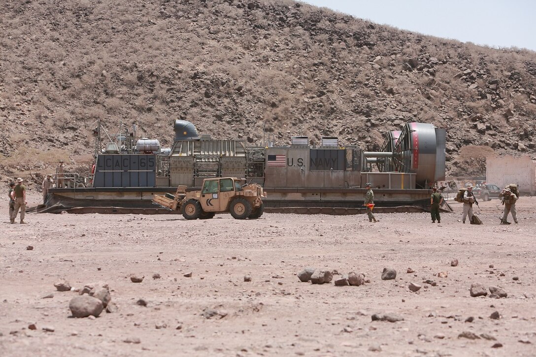 ARTA BEACH, DJIBOUTI (July 21, 2015) U.S. Marines off-load from a landing craft, air cushion at Arta Beach. Elements of the 15th Marine Expeditionary Unit came ashore in Djibouti to conduct sustainment training to maintain and enhance the skills they developed during their pre-deployment training period. The 15th MEU is currently deployed conducting maritime security operations in the 5th and 6th Fleet areas of responsibility. (U.S. Marine Corps photo by Sgt. Steve H. Lopez/Released)