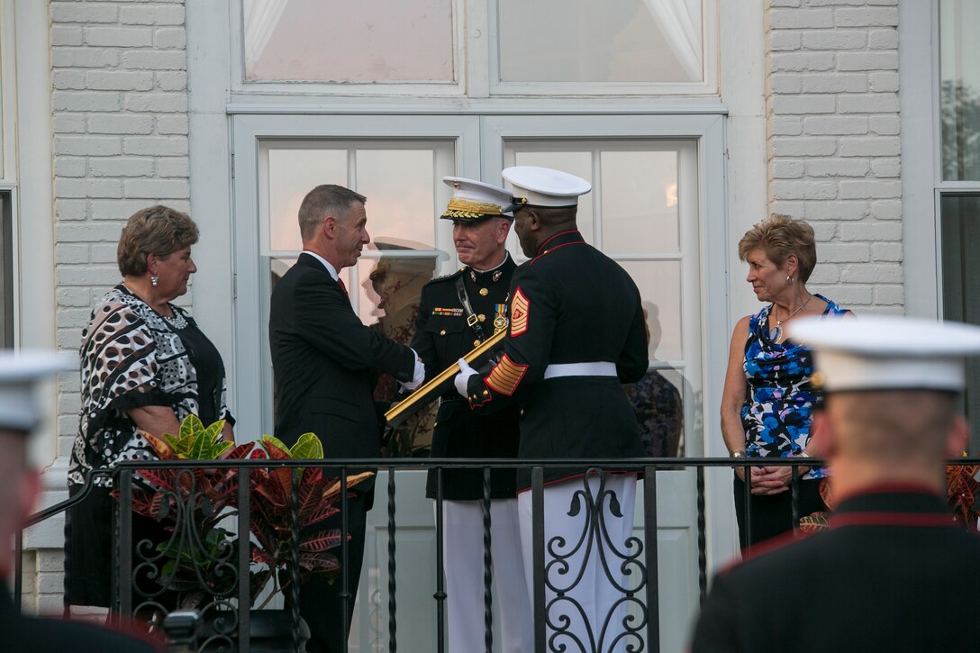 The Commandant of the Marine Corps, Gen. Joseph Dunford Jr. presents Congressman Robert Wittman with an Honorary Marine citation, July 27, 2015. During the honors ceremony at the Home of the Commandants in Washington, D.C., Wittman from the 1st Congressional District of Virginia, was named an Honorary Marine by Dunford for his extensive support of wounded warriors and his contributions to ensuring the readiness and care of active duty Marines and their families. We wanted to recognize Congressman Wittman tonight because of what he’s done for our wounded warriors behind the scenes, said Dunford. It hasn’t been with fanfare, it’s been because of his compassionate leadership. (U.S. Marine Corps photo by Cpl. Christian Varney/Released)