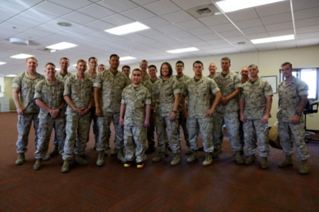 James Gallant, a young man diagnosed with brain cancer, poses for a photo with Marines of 1st Explosive Ordnance Disposal Company, 1st Marine Logistics Group, aboard Camp Pendleton, Calif., July 25, 2015. Collaborating with the Make-A-Wish Foundation, 1st EOD helped James experience what being an EOD technician is like by giving him a tour through their library of ordnance and EOD tools, teaching him to operate the TALON bomb disposing robot and presenting him with his own desert utilities and EOD badge.