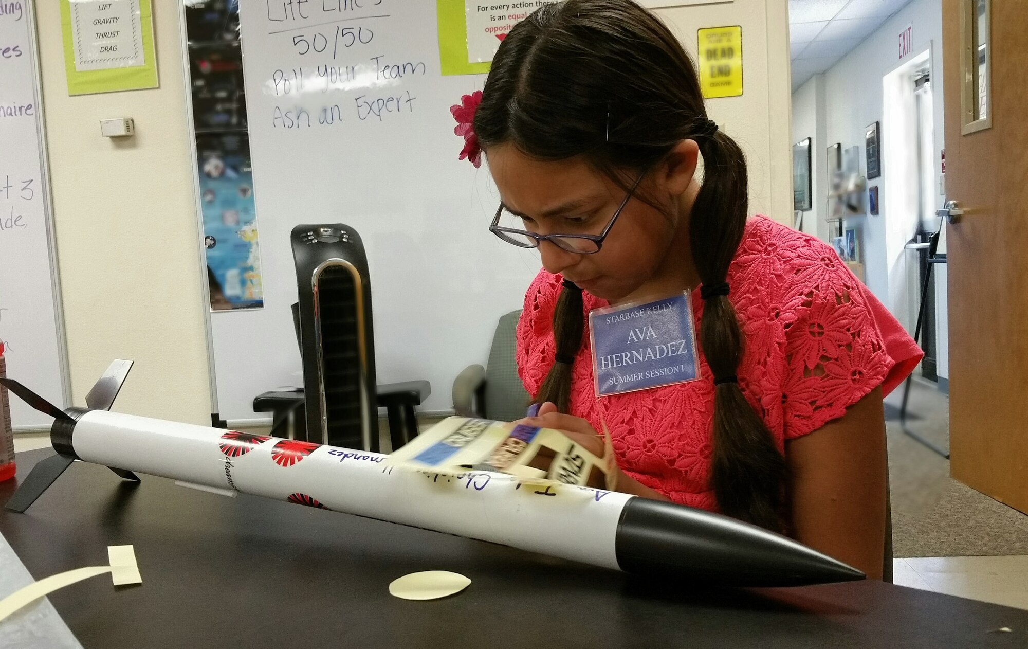 Ava Hernandez, a student at DoD STARBASE-Kelly, Joint Base San Antonio, Texas focuses on putting the finishing touches on her model rocket July 17, 2015. The DoD STARBASE-Kelly program is sponsored by the 433rd Airlift Wing. (U.S. Air Force photo/Tech. Sgt. Carlos J. Trevino)
