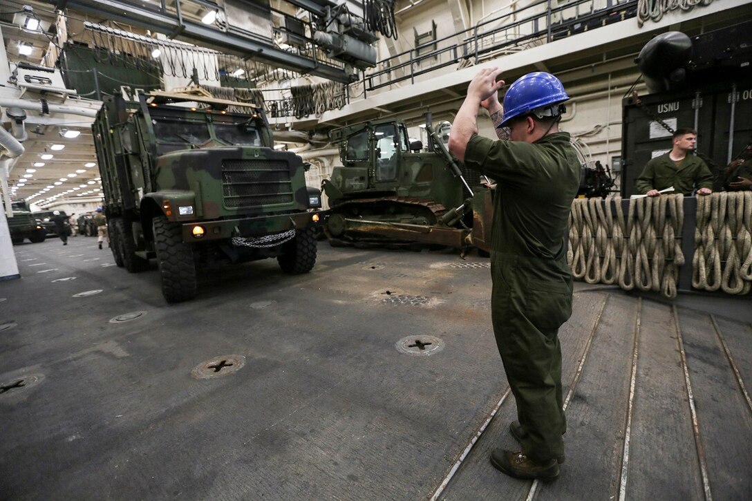ARABIAN SEA (July 20, 2015) U.S. Marine Lance Cpl. Garred Sims guides a Medium Tactical Vehicle Replacement (MTVR) onto a landing craft, air cushion aboard the amphibious transport dock ship USS Anchorage (LPD 23). Sims is a rifleman with Light Armored Reconnaissance Detachment, Battalion Landing Team 3rd Battalion, 1st Marine Regiment, 15th Marine Expeditionary Unit. Marines and sailors disembarked Anchorage to conduct training in Djibouti.  Elements of the 15th MEU are conducting training ashore in Djibouti to maintain the skills they developed during their pre-deployment training cycle and to ensure they are prepared to support regional security while deployed to the U.S. 5th Fleet area of operations. (U.S. Marine Corps photo by Sgt. Jamean Berry/Released)