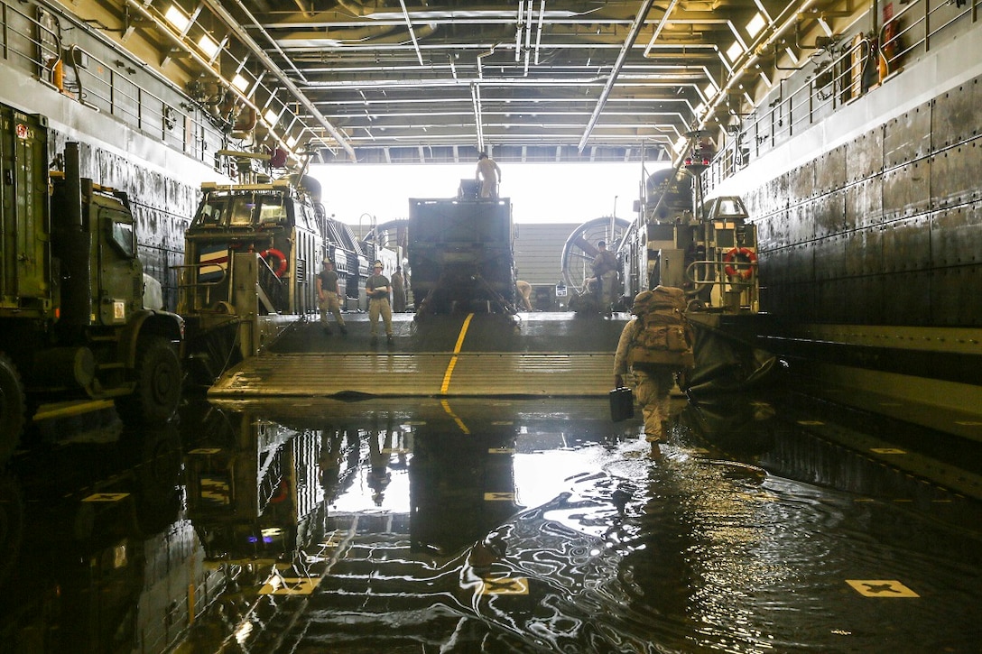 ARABIAN SEA (July 20, 2015)  U.S. Marines with Battalion Landing Team 3rd Battalion, 1st Marine Regiment, 15th Marine Expeditionary Unit, board a landing craft, air cushion in the well deck of the amphibious transport dock ship USS Anchorage (LPD 23).  Marines and sailors disembarked the Anchorage to conduct training in Djibouti.  BLT 3/1 is the ground combat element of the 15th MEU, is conducting training ashore in Djibouti to maintain the skills they developed during their pre-deployment training cycle and ensure they are prepared to support regional security while deployed to the U.S. 5th Fleet area of operations. (U.S. Marine Corps photo by Sgt. Jamean Berry/Released)