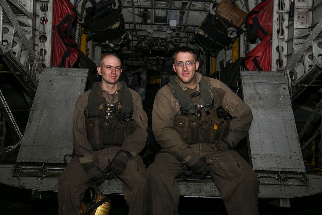 INDIAN OCEAN (July 26, 2015) U.S. Marine Cpl. Tanner Maynard, left, and Sgt. Tyler Kennedy sit in the back of a CH-53E Super Stallion aboard the Wasp-class amphibious assault ship USS Essex (LHD 2) July 26, 2015. Maynard and Kennedy are CH-53E crew chiefs with Marine Medium Tiltrotor Squadron 161 (Reinforced), 15th Marine Expeditionary Unit (MEU). As crew chiefs, these Marines monitor the structural integrity of the aircraft as well as acting as load masters and door gunners. They also serve an essential role during landing procedures and act as the pilot’s eyes. The crew chiefs add to the maneuverability of the aircraft. Elements of the 15th MEU, based out of Camp Pendleton, California, and embarked aboard the Essex, are conducting naval operations in the 6th Fleet areas of operation in support of U.S. national security interests in Europe and Africa. (U.S. Marine Corps photo by Cpl. Anna Albrecht/Released)