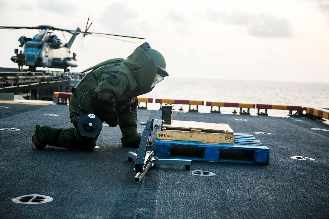 INDIAN OCEAN (July 27, 2015) U.S. Marine Staff Sgt. Peter Pearson inspects a simulated improvised explosive device (IED) during an anti-terrorism force-protection IED scenario aboard the amphibious assault ship USS Essex (LHD 2) July 27, 2015. Pearson is an explosive ordnance disposal technician with EOD detachment, Combat Logistics Battalion 15, 15th Marine Expeditionary Unit. Elements of the 15th MEU, based out of Camp Pendleton, California, and embarked aboard the Essex, are conducting naval operations in the 6th Fleet areas of operation in support of U.S. national security interests in Europe and Africa. (U.S. Marine Corps photo by Cpl. Anna Albrecht/Released)