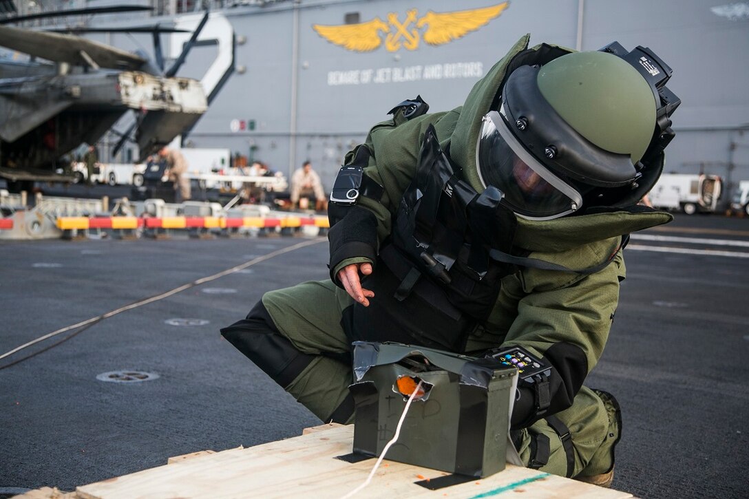 INDIAN OCEAN (July 27, 2015) U.S. Marine Staff Sgt. Peter Pearson inspects a simulated improvised explosive device (IED) during an anti-terrorism force-protection IED scenario aboard the amphibious assault ship USS Essex (LHD 2) July 27, 2015. Pearson is an explosive ordnance disposal technician with EOD detachment, Combat Logistics Battalion 15, 15th Marine Expeditionary Unit. Elements of the 15th MEU, based out of Camp Pendleton, California, and embarked aboard the Essex, are conducting naval operations in the 6th Fleet areas of operation in support of U.S. national security interests in Europe and Africa. (U.S. Marine Corps photo by Cpl. Anna Albrecht/Released)