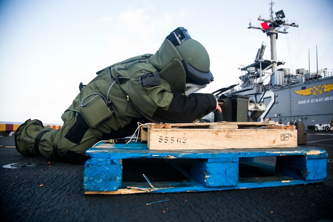 INDIAN OCEAN (July 27, 2015) U.S. Marine Staff Sgt. Peter Pearson inspects a simulated improvised explosive device (IED) during an anti-terrorism force-protection IED scenario aboard the amphibious assault ship USS Essex (LHD 2) July 27, 2015. Pearson is an explosive ordnance disposal technician with EOD detachment, Combat Logistics Battalion 15, 15th Marine Expeditionary Unit. Elements of the 15th MEU, based out of Camp Pendleton, California, and embarked aboard the Essex, are conducting naval operations in the 6th Fleet areas of operation in support of U.S. national security interests in Europe and Africa. (U.S. Marine Corps photo by Cpl. Anna Albrecht/Released)