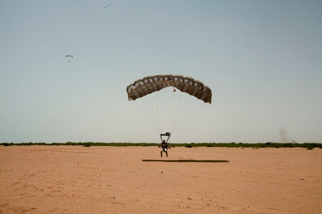 CAMP LEMONNIER, Djibouti (July 23, 2015) U.S. Marine Staff Sgt. Nicholas Bardsley glides to the ground after a free fall parachute operation. Bardsley is a member of the Force Reconnaissance Detachment, 15th Marine Expeditionary Unit. The Force Recon Det is ashore in Djibouti sustaining their parachute and diving skills during the 15th MEU’s deployment in support of maritime security operations and theater security cooperation efforts in the U.S. 5th Fleet area of operations. (U.S. Marine Corps photo by 1st Lt. Allison Burgos/Released)