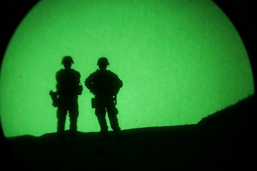 ARTA BEACH, Djibouti (July 22, 2015) U.S. Marines with Battalion Landing Team 3rd Battalion, 1st Marine Regiment, 15th Marine Expeditionary Unit, observe an impact area during a night-fire exercise.  The Marines of BLT 3/1 executed a series of attack and maneuver drills consisting of, machine gun, squad and night attacks.  Elements of the 15th Marine Expeditionary Unit are ashore in Djibouti for sustainment training to maintain and enhance the skills they developed during their pre-deployment training period.  The 15th MEU is currently deployed in support of maritime security operations and theater security cooperation efforts in the U.S. 5th and 6th Fleet areas of operation. (U.S. Marine Corps photo by Sgt. Jamean Berry/Released)