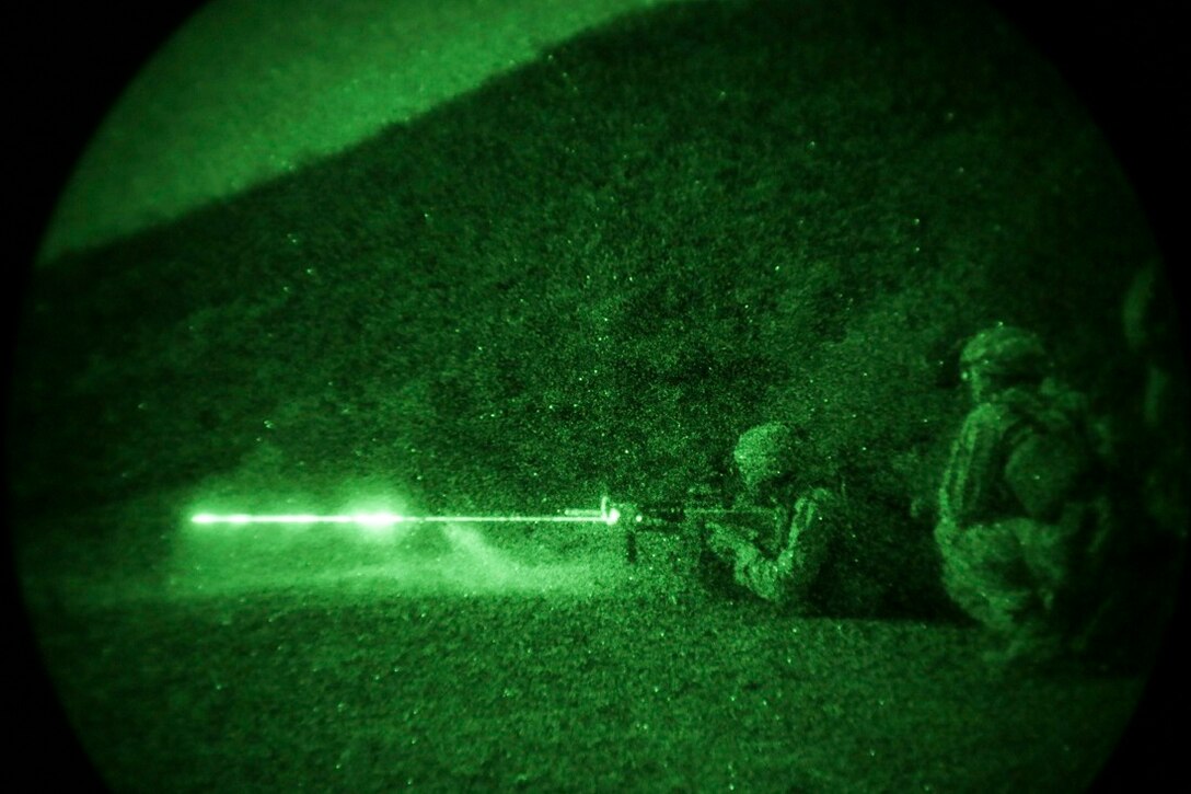 ARTA BEACH, Djibouti (July 22, 2015) A U.S. Marine with Battalion Landing Team 3rd Battalion, 1st Marine Regiment, 15th Marine Expeditionary Unit, fires an M4 Carbine during a night-fire exercise.  The Marines of BLT 3/1 executed a series of attack and maneuver drills consisting of, machine gun, squad and night attacks.  Elements of the 15th Marine Expeditionary Unit are ashore in Djibouti for sustainment training to maintain and enhance the skills they developed during their pre-deployment training period.  The 15th MEU is currently deployed in support of maritime security operations and theater security cooperation efforts in the U.S. 5th and 6th Fleet areas of operation. (U.S. Marine Corps photo by Sgt. Jamean Berry/Released)