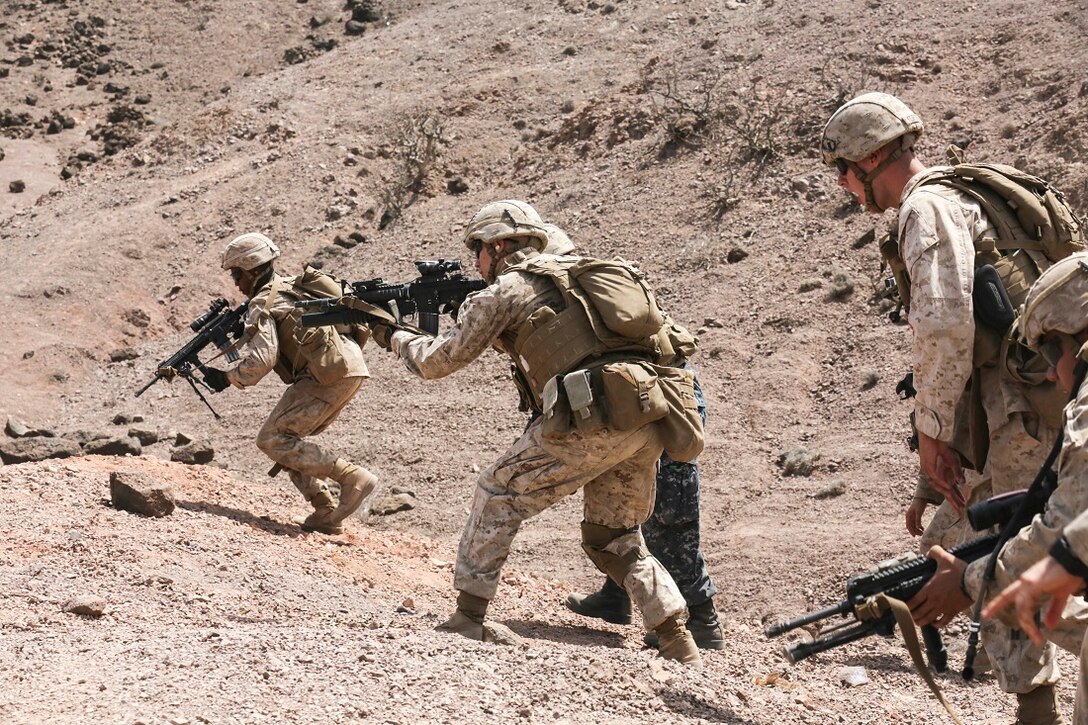 ARTA BEACH, Djibouti (July 22, 2015) U.S. Marines with Battalion Landing Team 3rd Battalion, 1st Marine Regiment, 15th Marine Expeditionary Unit, assault up to their fighting position during a squad-attack exercise.  The Marines of BLT 3/1 executed a series of attack and maneuver drills consisting of, machine gun, squad and night attacks.  Elements of the 15th Marine Expeditionary Unit are ashore in Djibouti for sustainment training to maintain and enhance the skills they developed during their pre-deployment training period.  The 15th MEU is currently deployed in support of maritime security operations and theater security cooperation efforts in the U.S. 5th and 6th Fleet areas of operation. (U.S. Marine Corps photo by Sgt. Jamean Berry/Released)