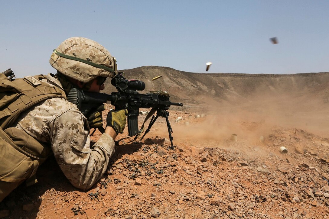 ARTA BEACH, Djibouti (July 22, 2015) A U.S. Marine with Battalion Landing Team 3rd Battalion, 1st Marine Regiment, 15th Marine Expeditionary Unit, fires an infantry automatic rifle during a squad-attack exercise.  The Marines of BLT 3/1 executed a series of attack and maneuver drills consisting of, machine gun, squad and night attacks.  Elements of the 15th Marine Expeditionary Unit are ashore in Djibouti for sustainment training to maintain and enhance the skills they developed during their pre-deployment training period.  The 15th MEU is currently deployed in support of maritime security operations and theater security cooperation efforts in the U.S. 5th and 6th Fleet areas of operation. (U.S. Marine Corps photo by Sgt. Jamean Berry/Released)
