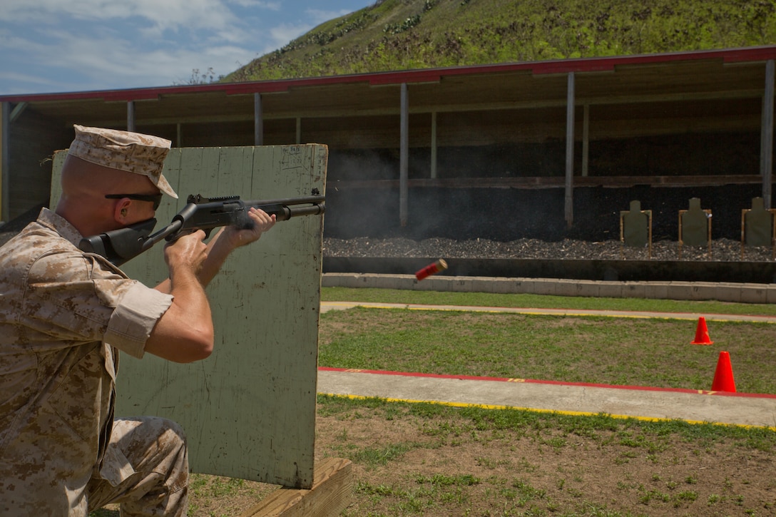 Master Gunnery Sgt. Christopher Benke, the provost sergeant with the Provost Marshal’s Office, fires his M1014 shotgun from the kneeling position during the practical weapons course, July 22, 2015, at Kaneohe Bay Range Training Facility. Marines with the PMO need to be proficient with not only the M16, but also the M1014 shotgun and the M9 pistol. The 140-acre range provides facilities for small arms marksmanship training, qualification, and requalification.  In addition to Marine Corps Base Hawaii Marines, the range is used by members of the Department of Defense, local law enforcement, and federal organizations. The mission of MCB Hawaii is to provide facilities, programs and services in direct support of units, individuals and families to enhance and sustain combat readiness for all operating forces and tenant organizations aboard the installation. (U.S. Marine Corps Cpl. Khalil Ross/Released)