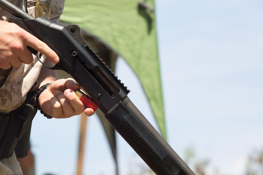Lance Cpl. William Hickman, an accident investigator with the Provost Marshal’s Office, loads his M1014 shotgun before he starts his practice fire session, July 22, 2015, at Kaneohe Bay Range Training Facility. Marines with the PMO need to be proficient and familiar with not only the M16, but also the M1014 shotgun and the M9 pistol. The 140-acre range provides facilities for small arms marksmanship training, qualification, and requalification.  In addition to Marine Corps Base Hawaii Marines, the range is used by members of the Department of Defense, local law enforcement, and federal organizations. The mission of MCB Hawaii is to provide facilities, programs and services in direct support of units, individuals and families to enhance and sustain combat readiness for all operating forces and tenant organizations aboard the installation. (U.S. Marine Corps Cpl. Khalil Ross/Released)