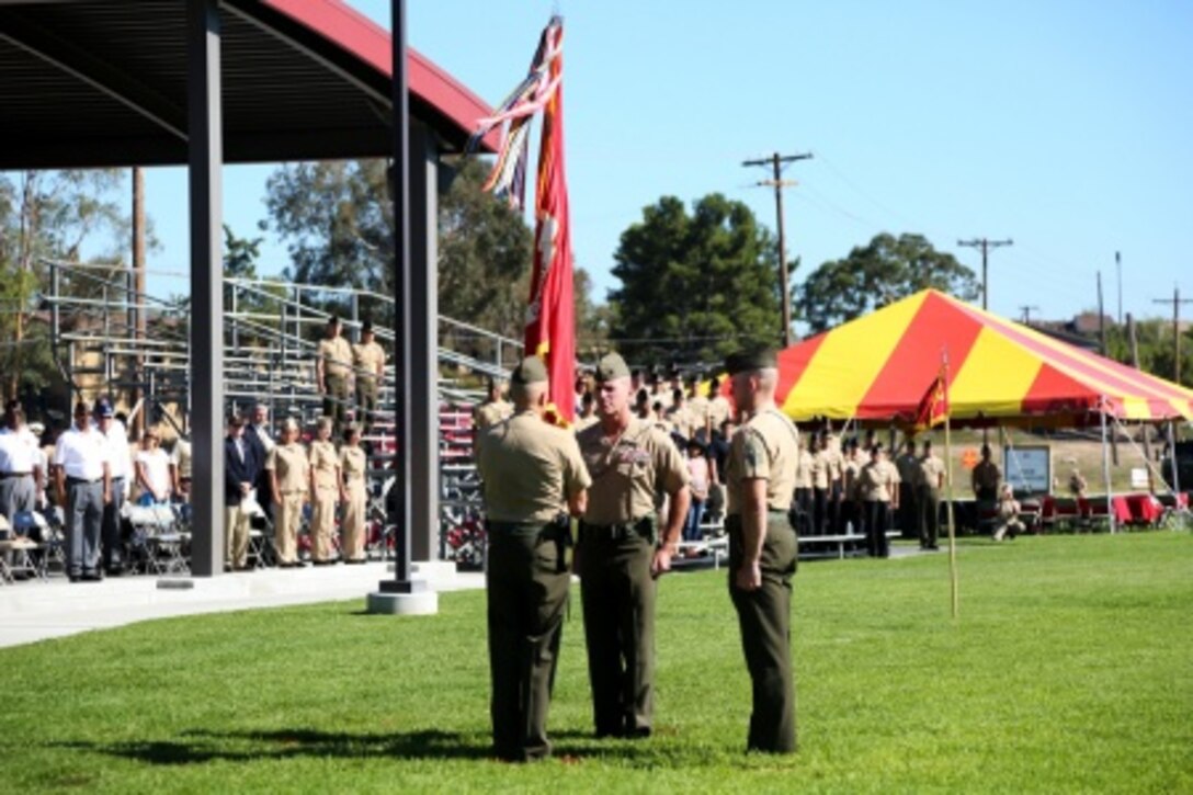 Major Gen. Vincent A. Coglianese passes the group colors to Brig. Gen. David A. Ottignon during the 1st Marine Logistics Group Change of Command Ceremony aboard Camp Pendleton, Calif., July 24, 2015. Coglianese relinquished command of 1st MLG to Ottignon during a change of command ceremony at the 11 Area Parade Field, July, 24, 2015. The ceremony included the passing of the 1st MLG colors, remarks from the incoming and outgoing commanders, performances by the 1st Marine Division Band, a C-130 flyover and static displays depicting the various aspects of the MLG.