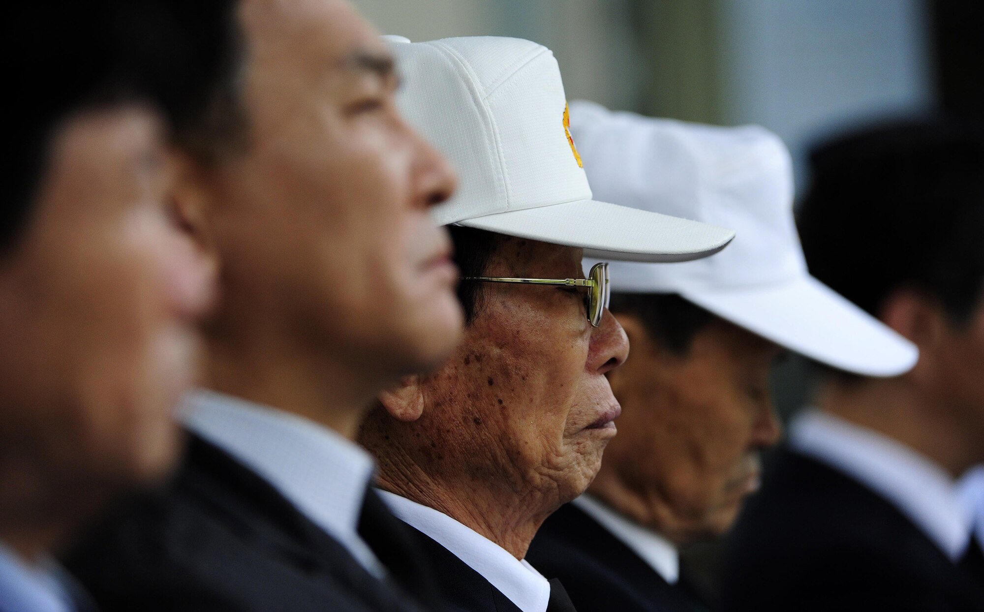 Mr. Kim Chun-il, Chairman, Korean War Veterans, Jeonbuk Province Chapter, Republic of Korea, watches the official proceedings of a Korean Armistice Agreement anniversary ceremony at Imsil National Cemetery, ROK, July 24, 2015. Approximately 36 Airmen attended the event as representatives of the wing, after being invited to take part by the ROK Ministry of Patriots and Veterans Affairs. (U.S. Air Force photo by Staff Sgt. Nick Wilson/Released)