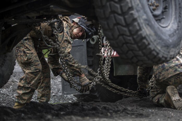 Cpl. Gerardo Becerra, a motor transport operator with Combat Logistics Company 36, attaches an abandoned vehicle to an AMK-36 wrecker during Exercise Dragon Fire 2015 at Combined Arms Training Center Camp Fuji, Japan, July 24. Convoy and recovery operations are one of the many activities Marines and Sailors practiced during the exercise. CLC-36 conducts this exercise annually to refresh the minds of the service members of all the tactical skill sets that leaned about in boot camp and Marine combat training. This training environment simulated a combat zone in order to further develop the service members’ combat mindset to prepare them for the mental and physical stress of a combat zone.