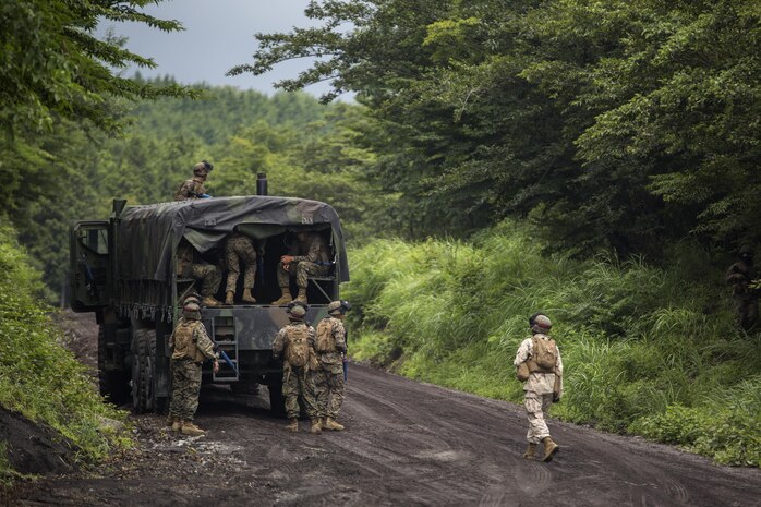 Marines and Sailors with Combat Logistics Company 36 load onto an AMK-27 medium tactical vehicle during Exercise Dragon Fire 2015 at Combined Arms Training Center Camp Fuji, Japan, July 24. During the exercise, service members practiced convoy operations in a simulated combat zone with enemy fire and hidden improvised explosive devices. Putting them in this simulated combat environment helped develop their combat mindset to prepare them for the mental and physical stress of a combat zone. CLC-36 conducts this exercise annually to further enhance the skills service members learn at boot camp and Marine combat training, making them more combat ready.