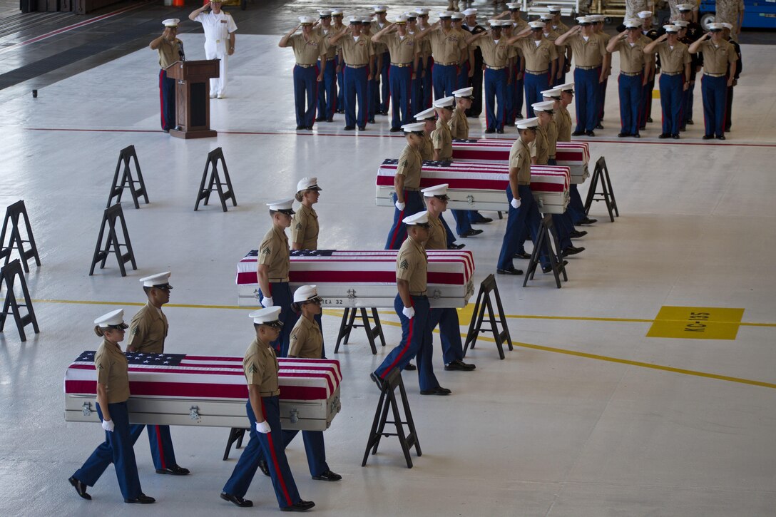 U.S. Marines with U.S. Marine Corps Forces, Pacific carry the remains of Marines who had fallen during World War II at the Battle of Tarawa during a Dignified Transfer Ceremony July 26, 2015. During the ceremony, the remains of approximately 36 U.S. Marines were returned to American soil. (U.S. Marine Corps photo by Sgt. William Holdaway/RELEASED)