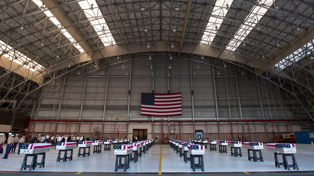 The remains of U.S. Marines who had fallen during World War II at the Battle of Tarawa rest in an aircraft hangar on Joint Base Pearl Harbor/Hickam after a Dignified Transfer Ceremony July 26, 2015. During the ceremony, the remains of approximately 36 U.S. Marines were returned to American soil. (U.S. Marine Corps photo by Sgt. William Holdaway/RELEASED)