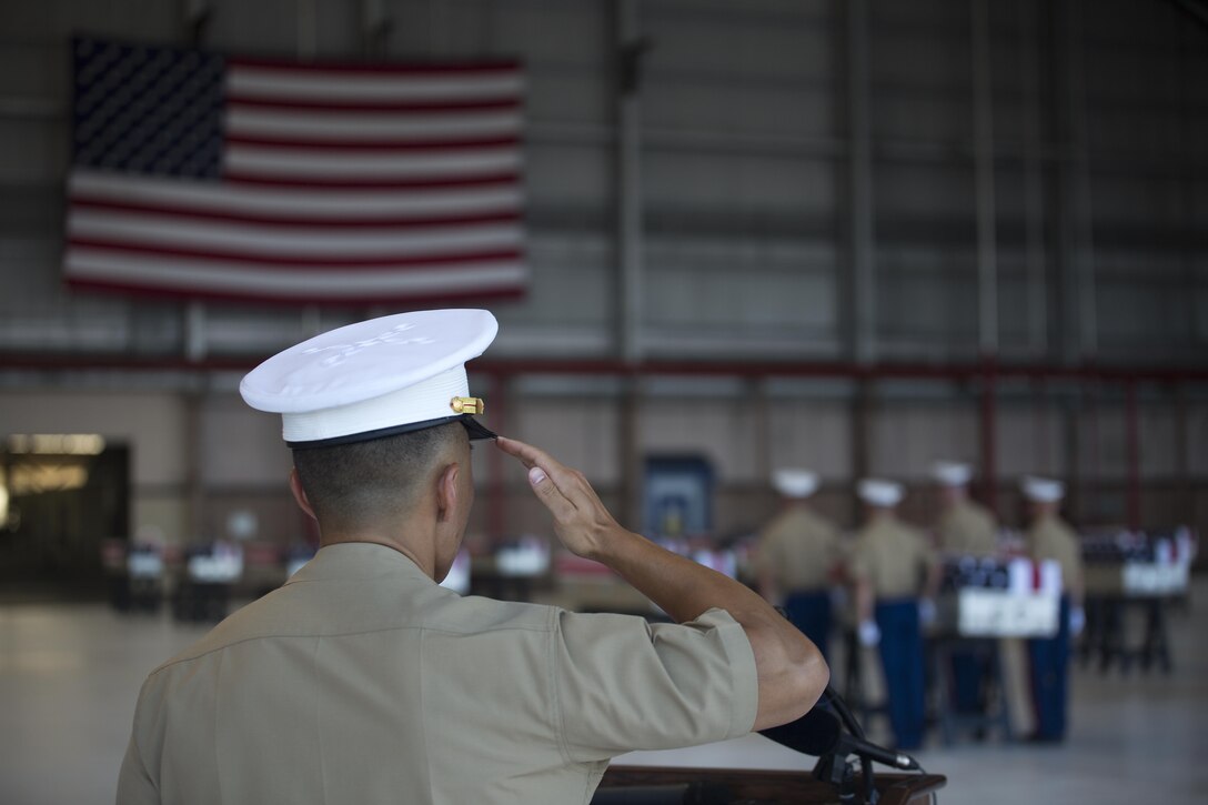Capt. Alex H. Lim, a U.S. Marine Corps Forces, Pacific public affairs officer, salutes the remains of 36 Marines, July 26, 2015, during a dignified transfer ceremony at Hangar 35 aboard Joint Base Pearl Harbor-Hickam, Hawaii. The remains of 36 Marines who fought and died during the Battle of Tarawa in World War II were honored in both Tarawa and the U.S., marking the Marines' return home for the first time in 70 years. (U.S. Marine Corps photo by Cpl. Matthew J. Bragg)