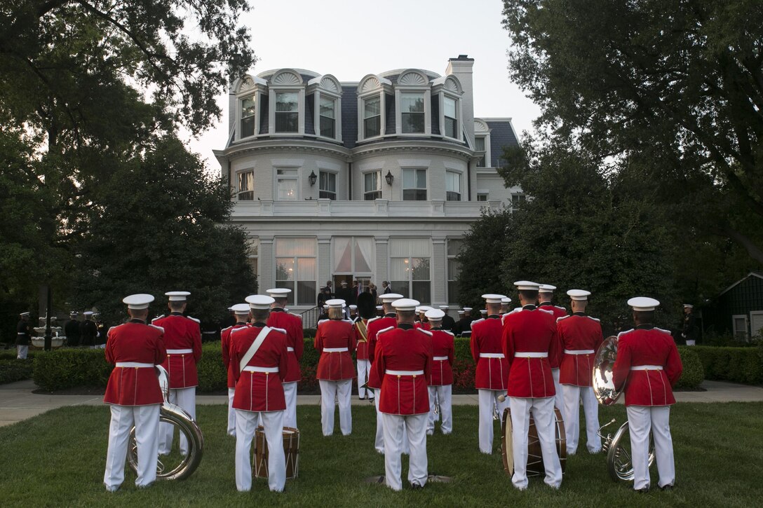 The US Marine Band stands at ceremonial at ease after an honors ceremony at the Home of the Commandants in Washington, D.C., July 27, 2015.  During the ceremony Congressman Robert Wittman from the 1st Congressional District of Virginia, was named an Honorary Marine by Gen. Joseph Dunford Jr., commandant of the Marine Corps, for his extensive support of wounded warriors and his contributions to ensuring the readiness and care of active duty Marines and their families. We wanted to recognize Congressman Wittman tonight because of what he’s done for our wounded warriors behind the scenes, said Dunford. It hasn’t been with fanfare, it’s been because of his compassionate leadership. (U.S. Marine Corps photo by Cpl. Christian Varney/Released)