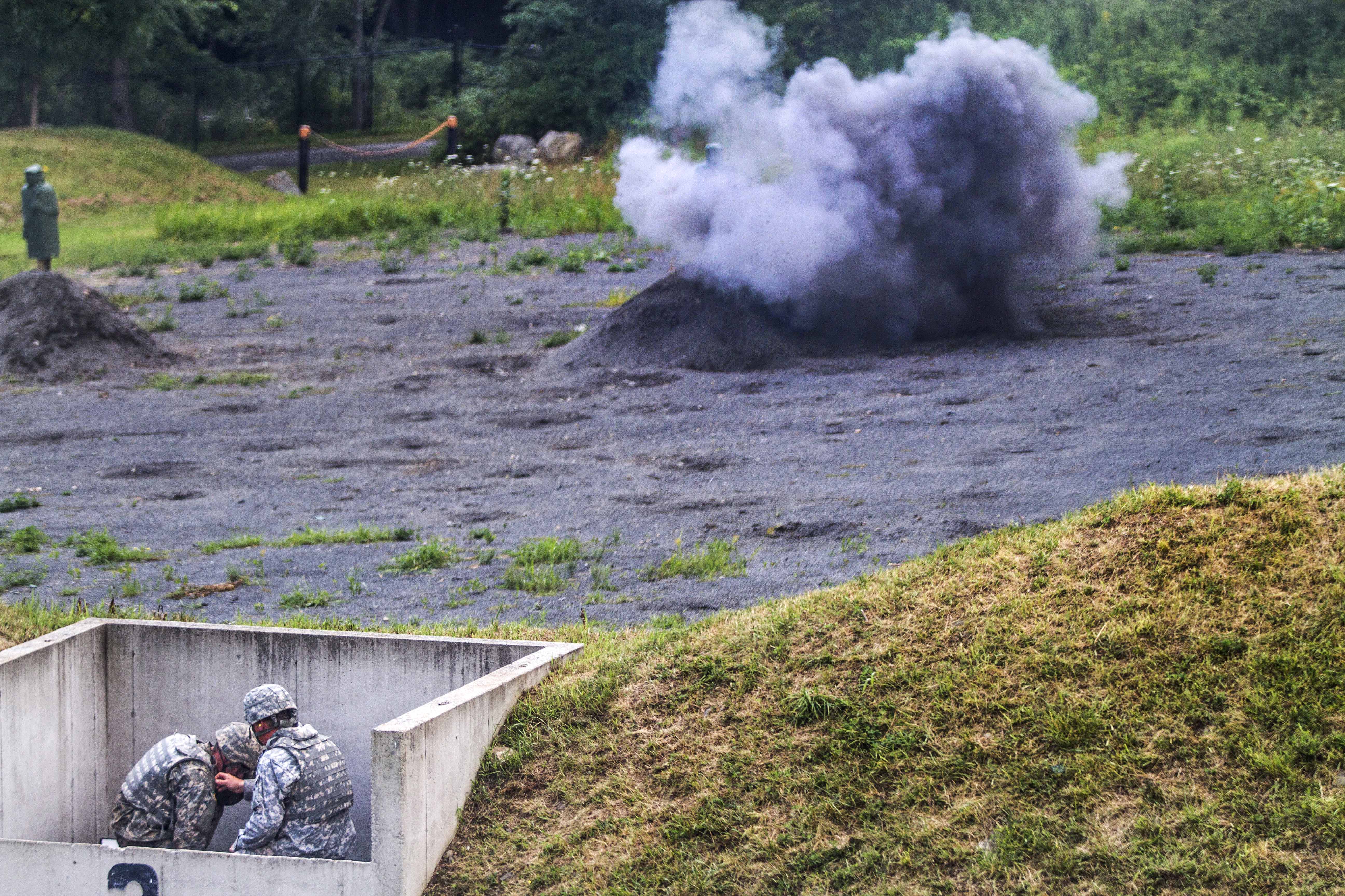 New cadets throw live grenades at targets under the direct supervision