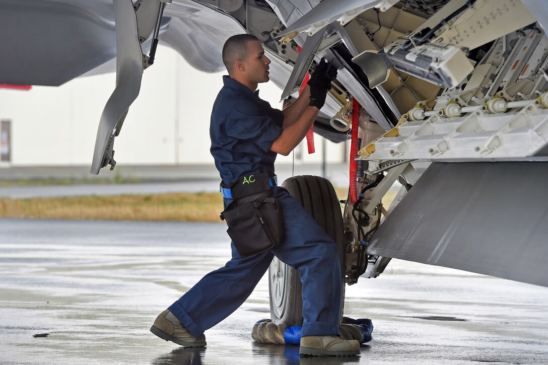 Air Force Senior Airman Frankie Ayala Cedeno prepares to arm an F-22 ...