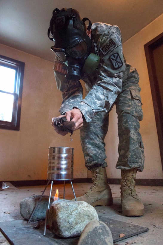 Army Spc. Jose O. Incleramos vaporizes CS capsules while preparing for chemical, biological, radiological and nuclear sustainment training on Joint Base Elmendorf-Richardson, Alaska, July 16, 2015. Incleramos is a CBRN specialist assigned to Company C, 307th Expeditionary Signal Battalion.