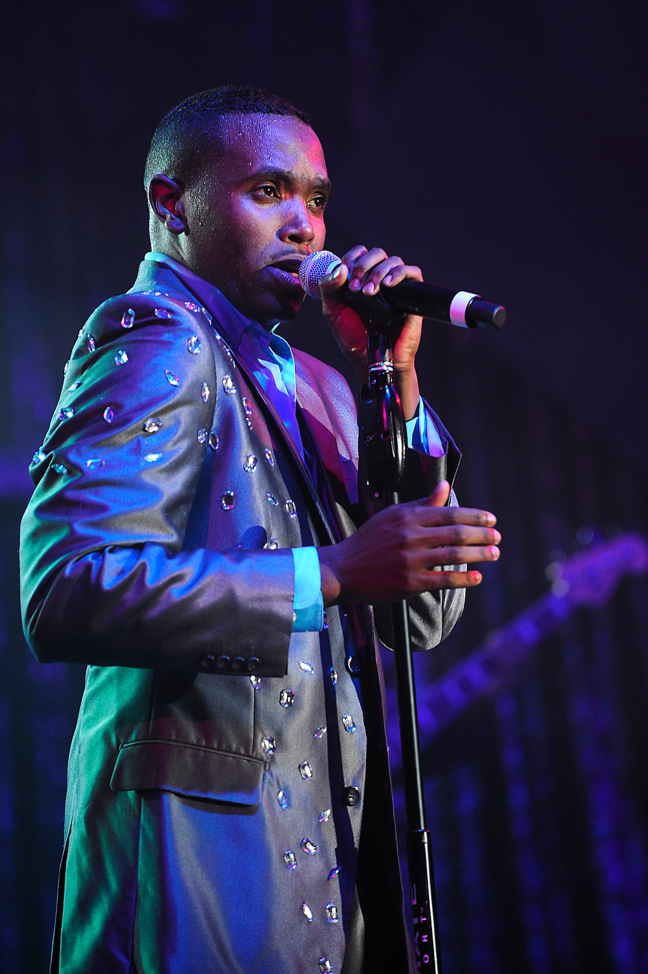 U.S. Air Force Airman 1st Class Mitchell Dixon, Tops in Blue vocalist, sings to the crowd during a performance at the Keystone Theater on Kadena Air Base, Japan, July 22, 2015. Tops in Blue serves as an expeditionary entertainment unit tasked with providing quality entertainment for the worldwide Air Force family. This year’s performance, “Freedom’s Song,” is being performed for service members and their families throughout the United States as well as 20 countries worldwide. (U.S. Air Force photo by Airman 1st Class Corey Pettis) 
