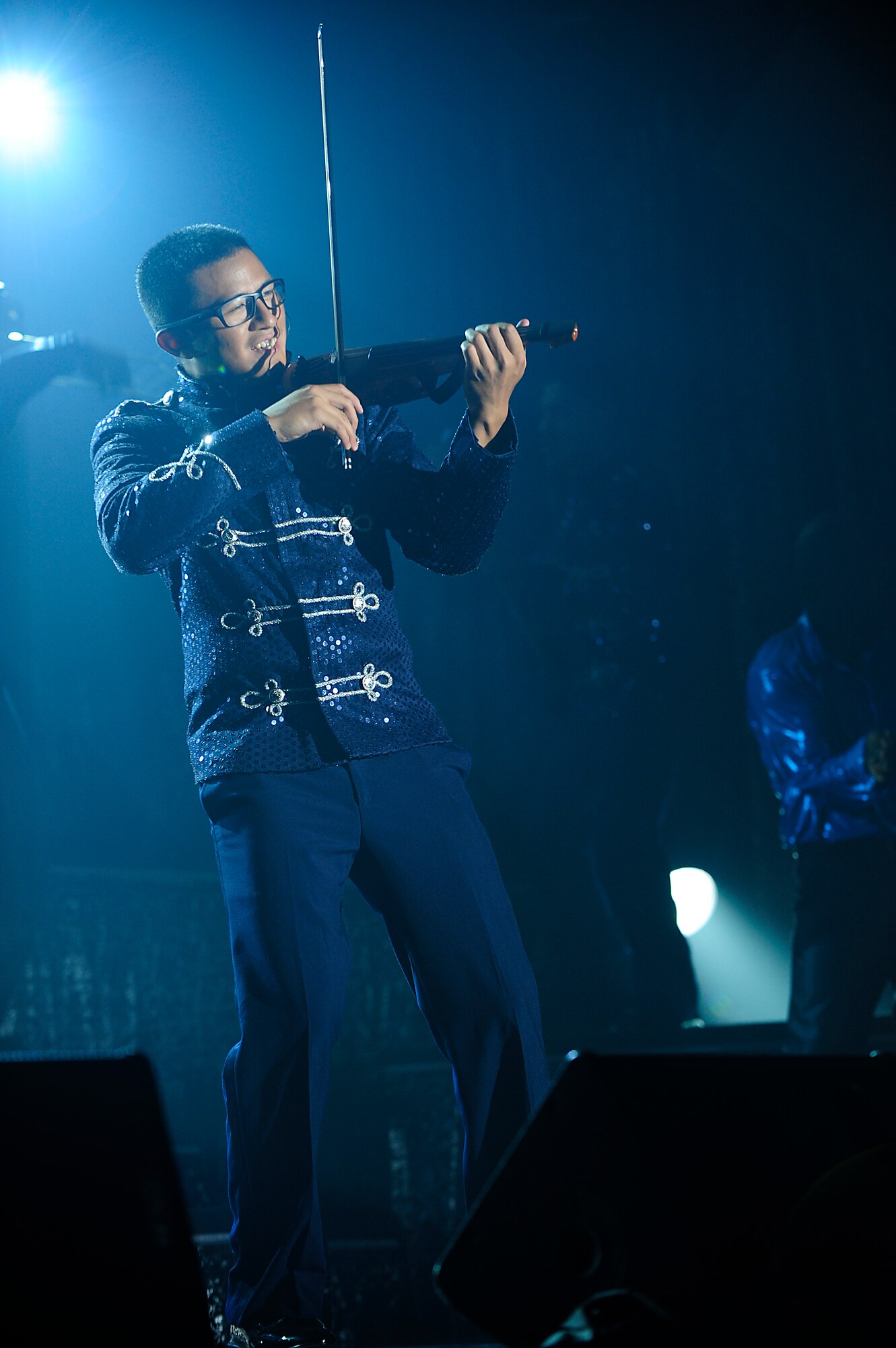U.S. Air Force 1st Lt. Oliver Chang, Tops in Blue violinist, performs in front of the crowd at the Keystone Theater on Kadena Air Base, Japan, July 22, 2015. Tops in Blue serves as an expeditionary entertainment unit tasked with providing quality entertainment for the worldwide Air Force family. This year’s performance, “Freedom’s Song,” is being performed for service members and their families throughout the United States as well as 20 countries worldwide. (U.S. Air Force photo by Airman 1st Class Corey Pettis) 
