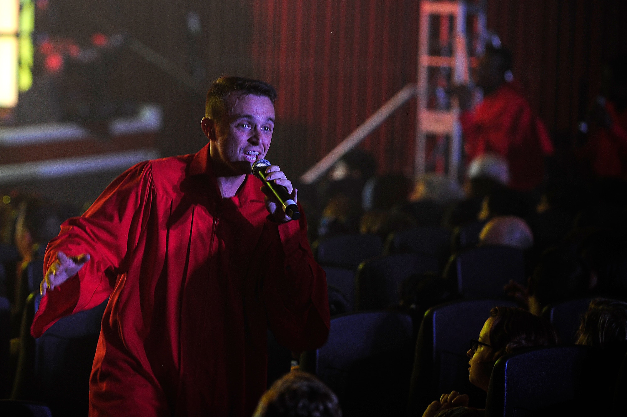 U.S. Air Force Staff Sgt. Steven Lucas, Tops in Blue vocalist, sings to the crowd during a performance at the Keystone Theater on Kadena Air Base, Japan, July 22, 2015. Tops in Blue serves as an expeditionary entertainment unit tasked with providing quality entertainment for the worldwide Air Force family. This year’s performance, “Freedom’s Song,” is being performed for service members and their families throughout the United States as well as 20 countries worldwide. (U.S. Air Force photo by Airman 1st Class Corey Pettis) 