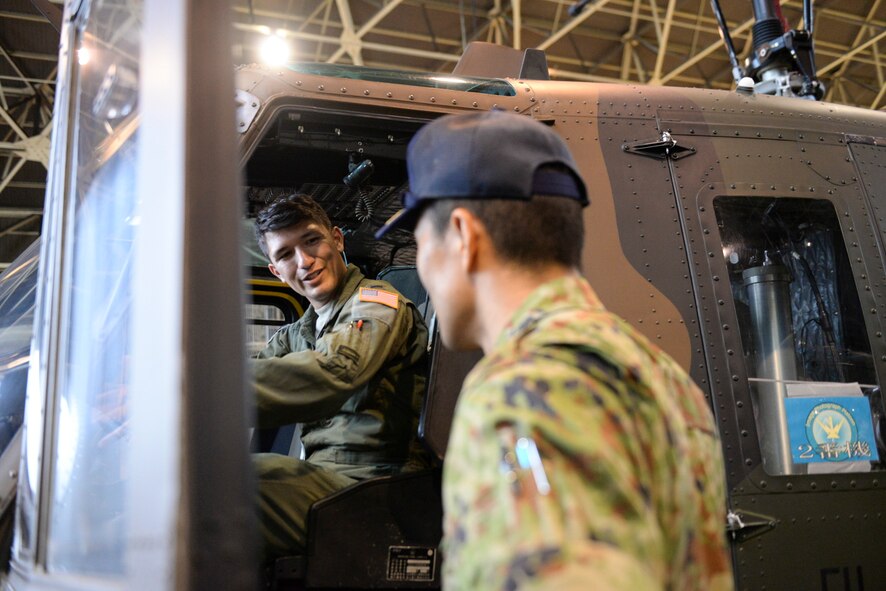 1st Lt. Vicente Vasquez, 459th Airlift Squadron scheduling officer, sits in a UH-1J Huey at Tachikawa Air Base, Japan, July 16, 2015. Japan Ground Self-Defense Force hosted a static display for members of the 459 AS, including the UH1-J, which is the equivalent to Yokota Air Base’s UH-1N. (U.S. Air Force photo by Airman 1st Class Elizabeth Baker/Released)