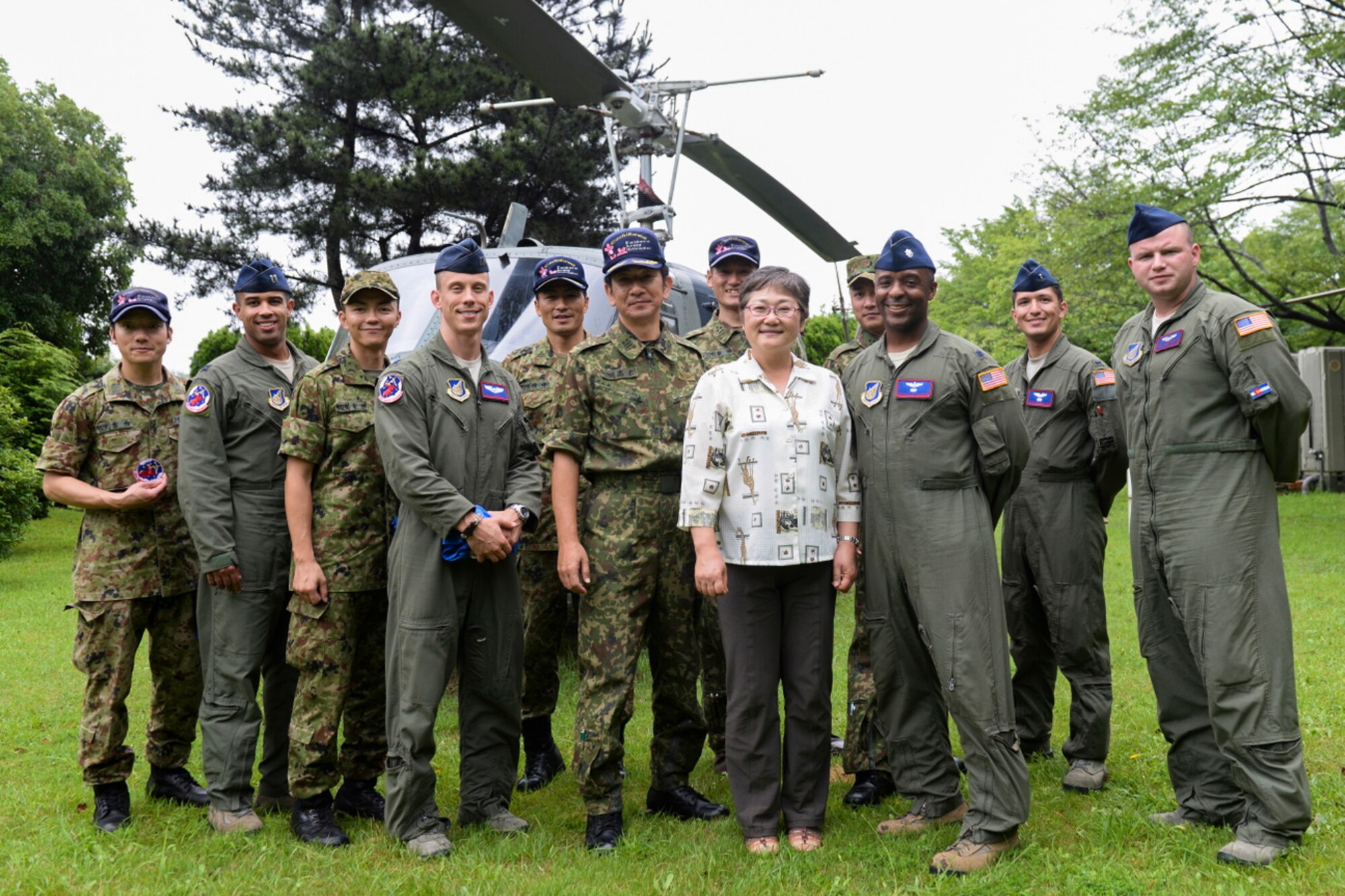 Members from the Japan Ground Self-Defense Force and the 459th Airlift Squadron pose for a photo at Tachikawa Air Base, Japan, July 16, 2015.  Tachikawa AB invited the 459 AS to tour the base, view a static display while discussing some of their air capabilities and enjoy lunch. (U.S. Air Force photo by Airman 1st Class Elizabeth Baker/Released)