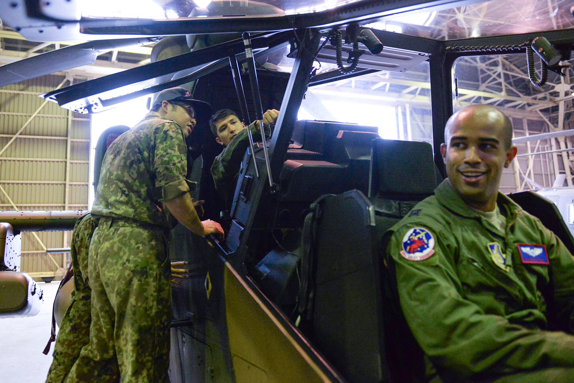 Members of the Japan Ground Self-Defense Force introduce Airmen from the 459th Airlift Squadron to an OH-1 Omega helicopter at Tachikawa Air Base, Japan, July 16, 2015. JGSDF hosted a static display while discussing some of its air capabilities for the 459 ALS. (U.S. Air Force photo by Airman 1st Class Elizabeth Baker/Released)