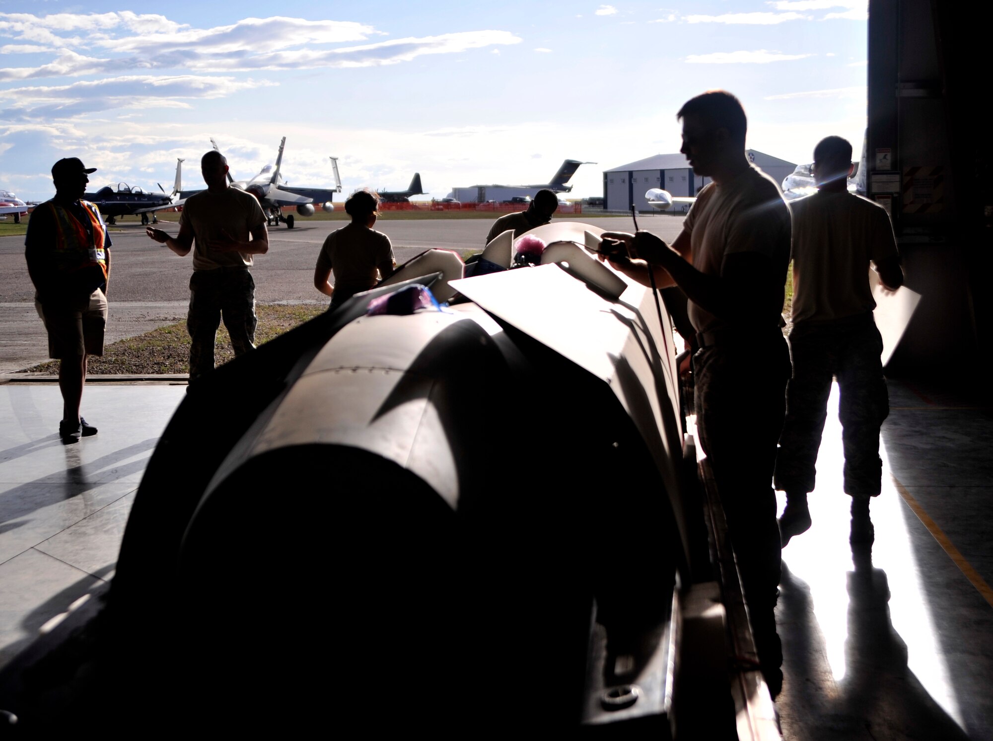 Members of the 432nd Aircraft Maintenance Squadron, Creech Air Force Base, Nevada pack an MQ-1 Predator in its 'casket' July 25, 2015, in Lethbridge, Canada. The aircraft and crew participated in a static display at the 2015 Lethbridge International Airshow July 24-25, 2015, and allowed spectators to see the aircraft and have an open line of communication with the crew who operate and maintain it. (U.S. Air Force photo by Airman 1st Class Christian Clausen/Released)
