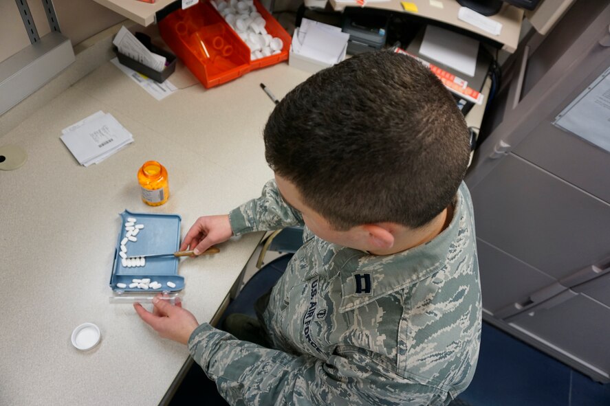Capt. Alex Ushkin, 90th Medical Support Squadron pharmacy operations chief, counts out the proper dosage of a patient's medication at the 90th Medical Group medical treatment facility pharmacy, F.E. Warren Air Force Base, Wyo., earlier this year. The Warren pharmacy is now on line with e-prescribing enabling off-base providers to quickly and securely send prescriptions to the base pharmacy for TRICARE beneficiaries. (U.S. Air Force photo by Lan Kim)