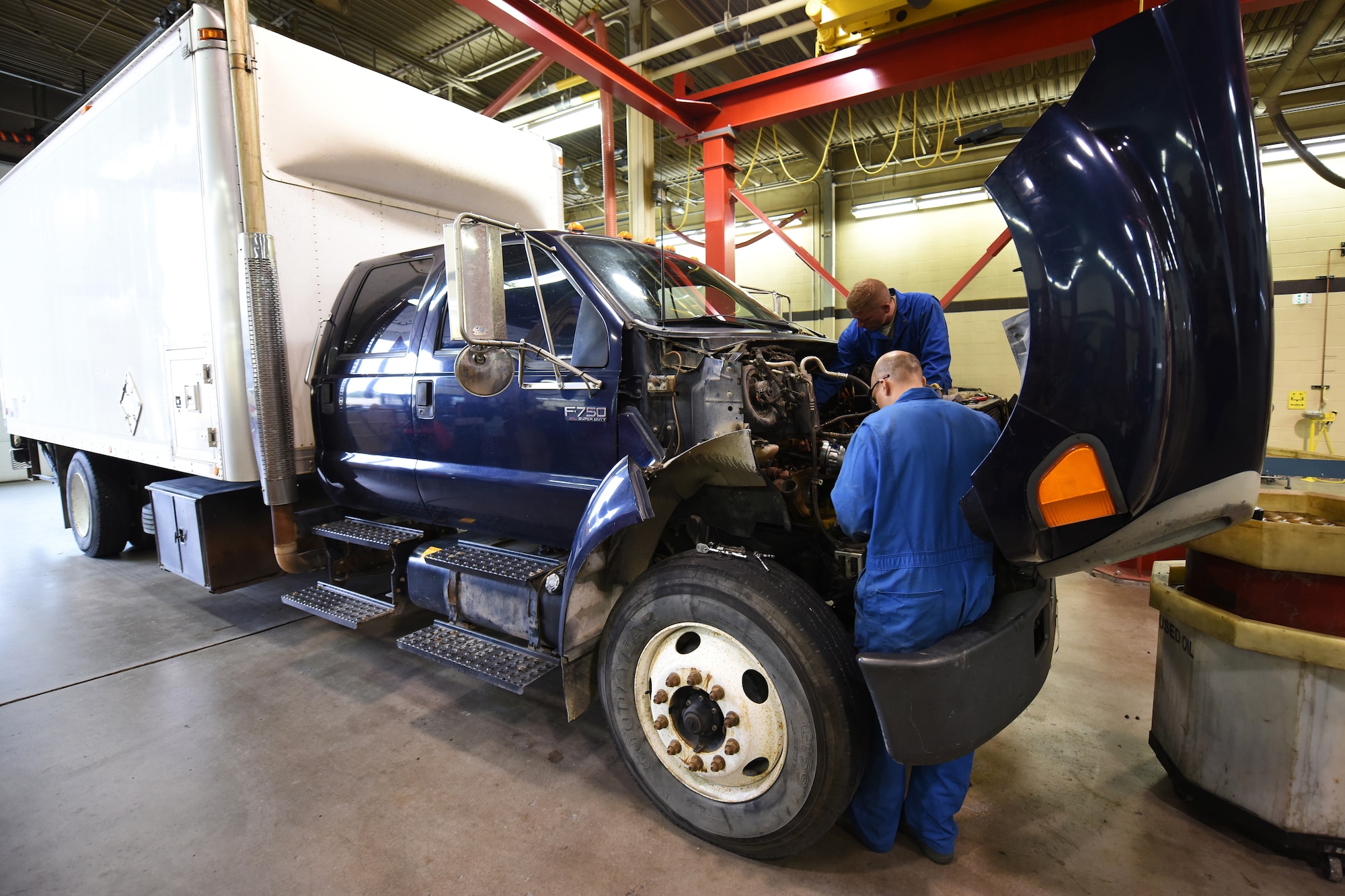 Members of the 341st Logistics Readiness Squadron truck and tractor maintenance shop work on a maintenance van engine July 27, 2015, at Malmstrom Air Force Base, Mont. The shop upholds a 96.8 percent of maintenance vans available to do the base mission. (U.S. Air Force photo/Chris Willis)